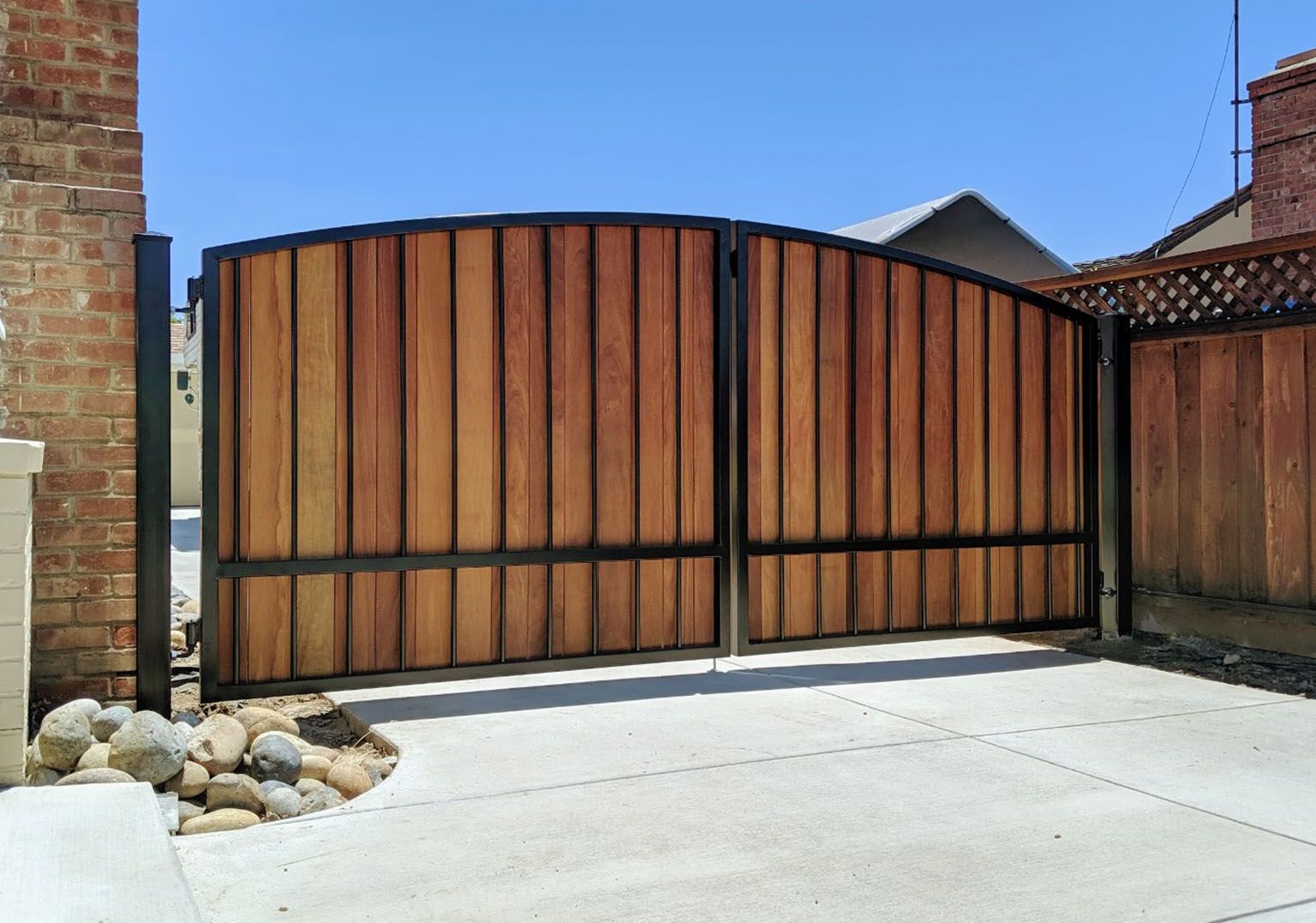 Powdercoated steel and ironwood driveway gate, installed