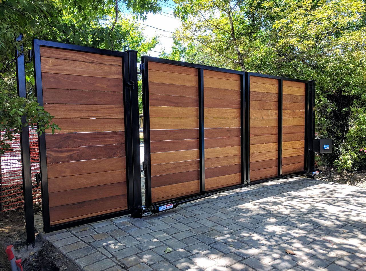 Black steel driveway gate with horizontal wood privacy infill